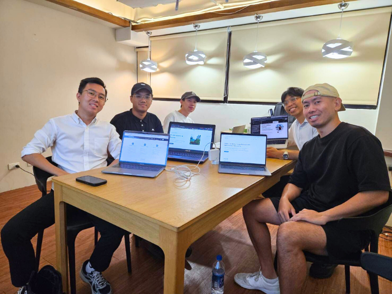 Build with AI bootcamp participants collaborating on their projects with laptops